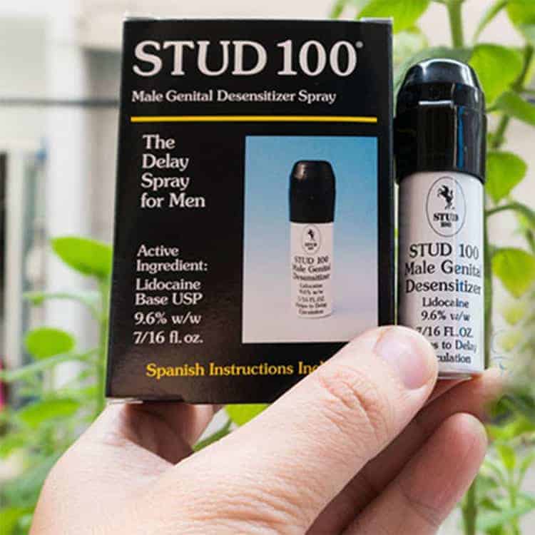 Genuine Stud 100 spray bottle held in hand